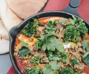 Shakshouka topped with ground lamb