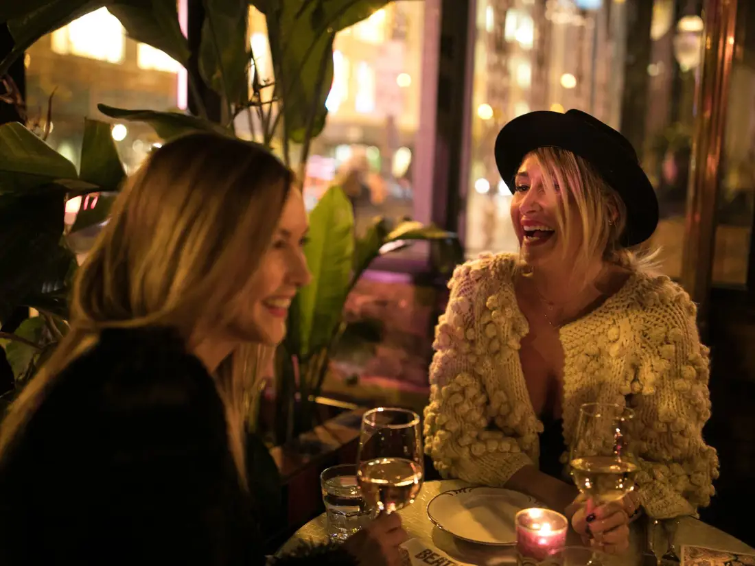 Guests laughing over wine