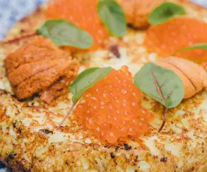 Tortilla topped with uni and roe
