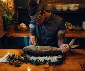 Closeup of Nathan butchering fish