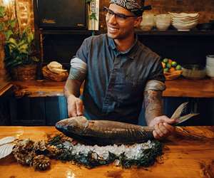 Nathan smiling while butchering fish